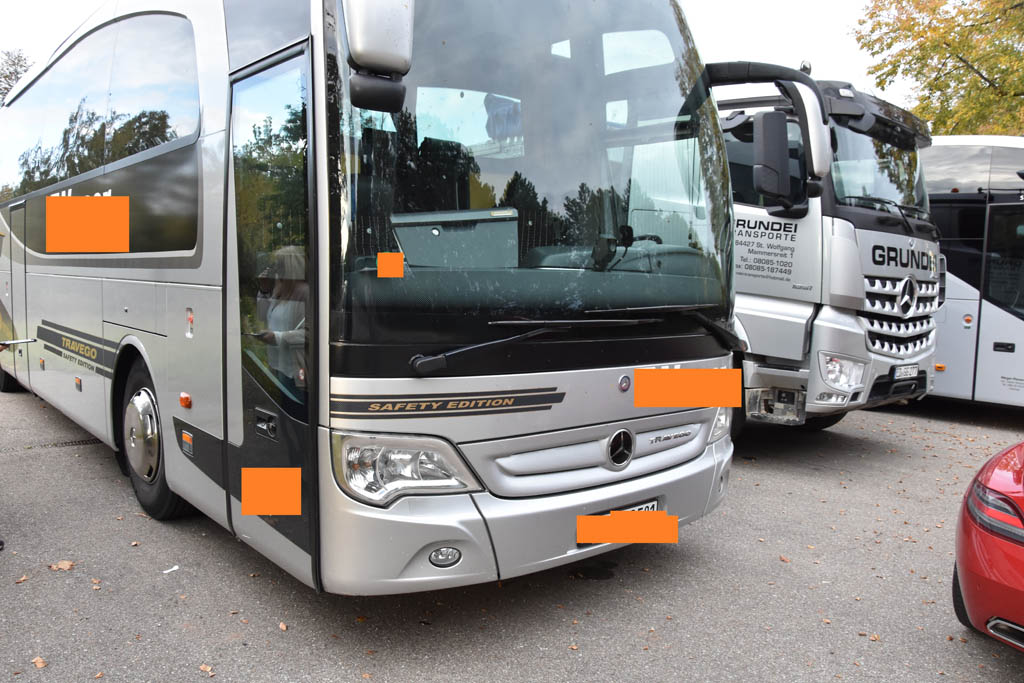Tourist bus coach rides on the road among the rocks in mountains
